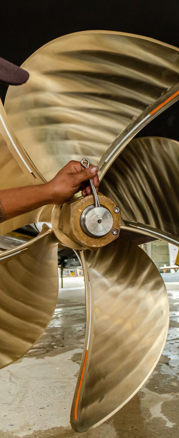 Marine engineer inspecting an OEM propeller during technical evaluation